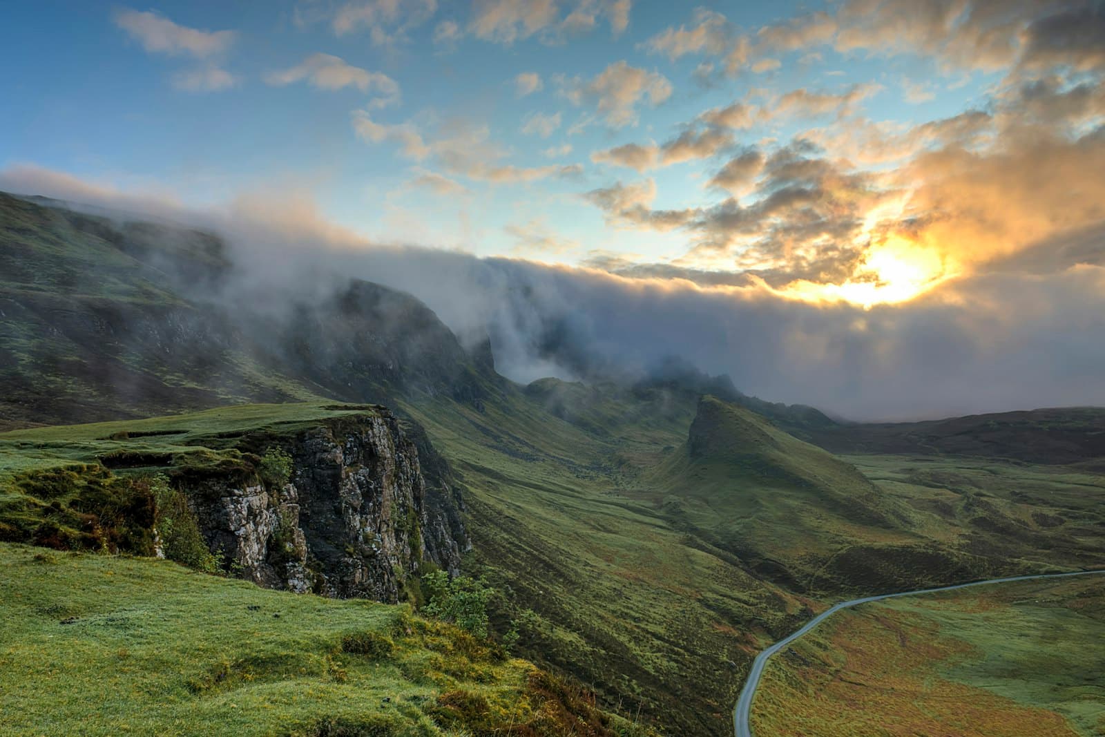 Fog rolling over layered mountain ridges